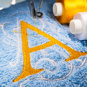 Gold "A" machine embroidered on a blue towel