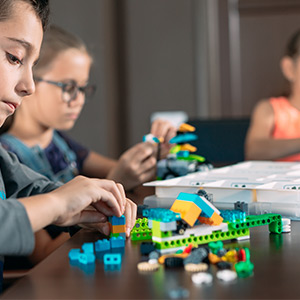 Kids building with plastic bricks
