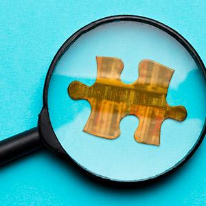 A magnifying glass hovered over a puzzle piece