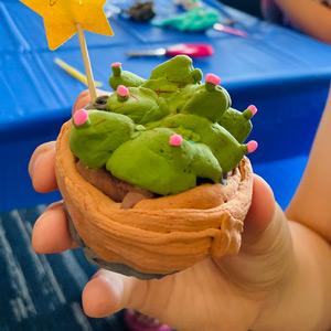 Child holding their clay creation