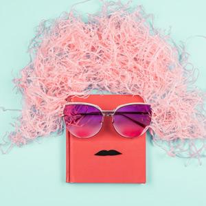 Hardcover book "wearing" a wig, sunglasses, and a fake mustache