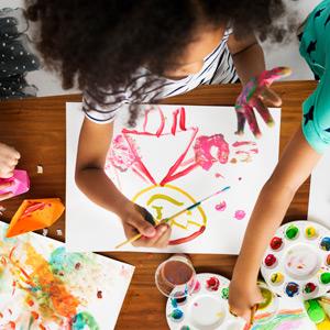 Overhead view of girl painting a portrait