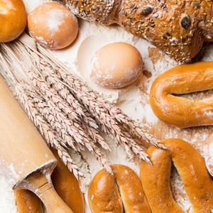 Grouping of wheat, eggs, flour, and freshly baked bread