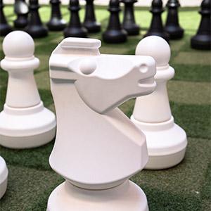 Giant chess pieces with knight in foreground