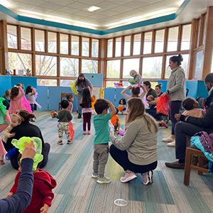 Kids and parents having fun during storytime in youth services