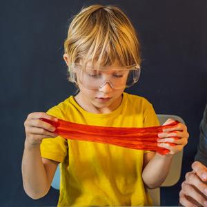 Child stretching slime between their hands