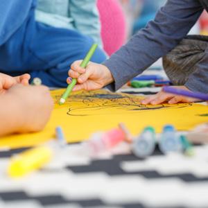 Kids sitting on the floor making art together