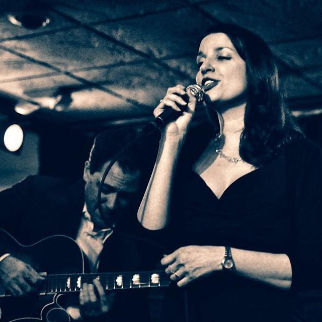 Petra van Nuis sings, while Andy Brown plays guitar. Photo by Thomas Cray.